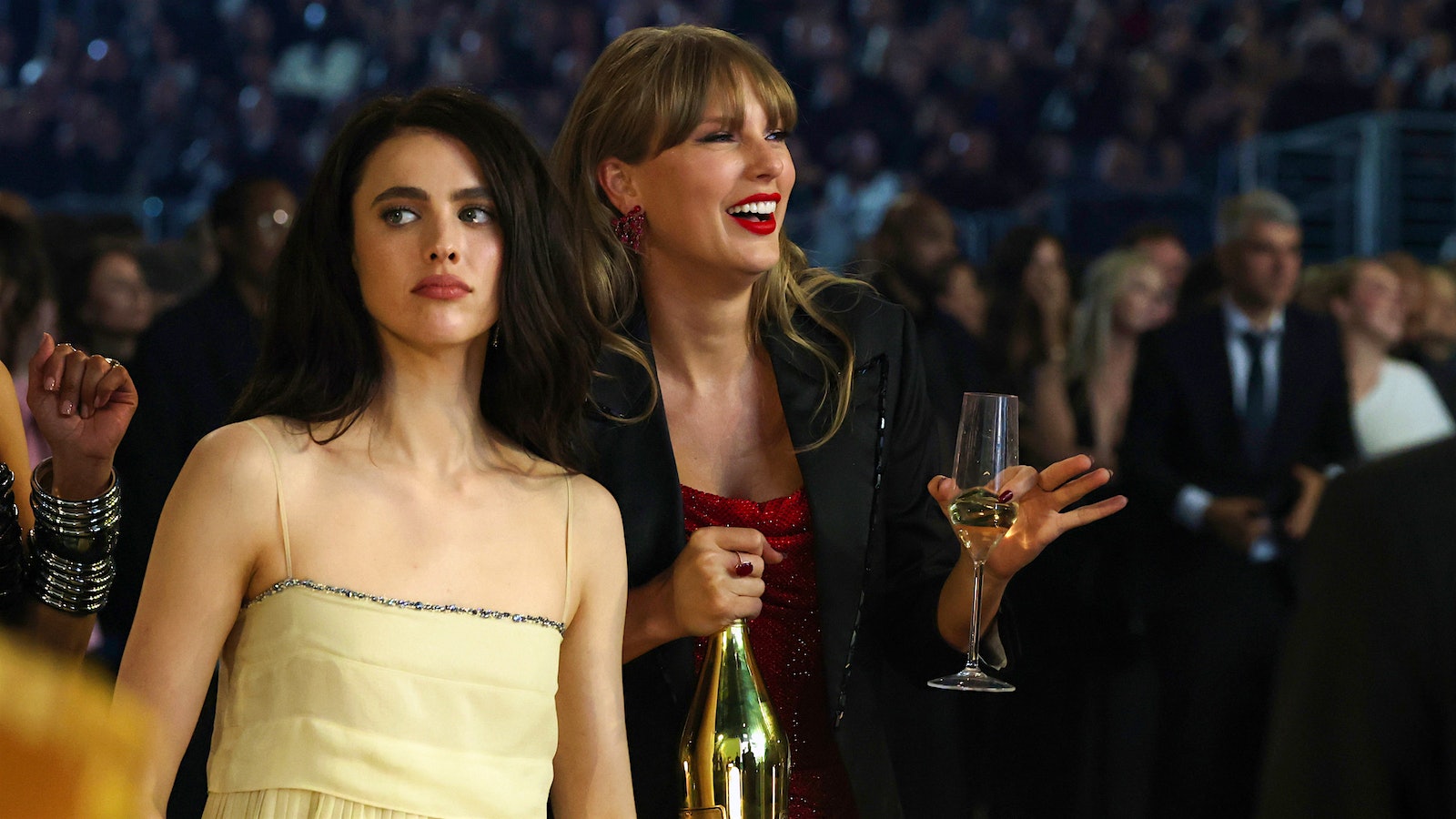 Taylor Swift double fists the Ace of Spades at the 2025 Grammy Awards while actress Margaret Qualley side-eyes the haters